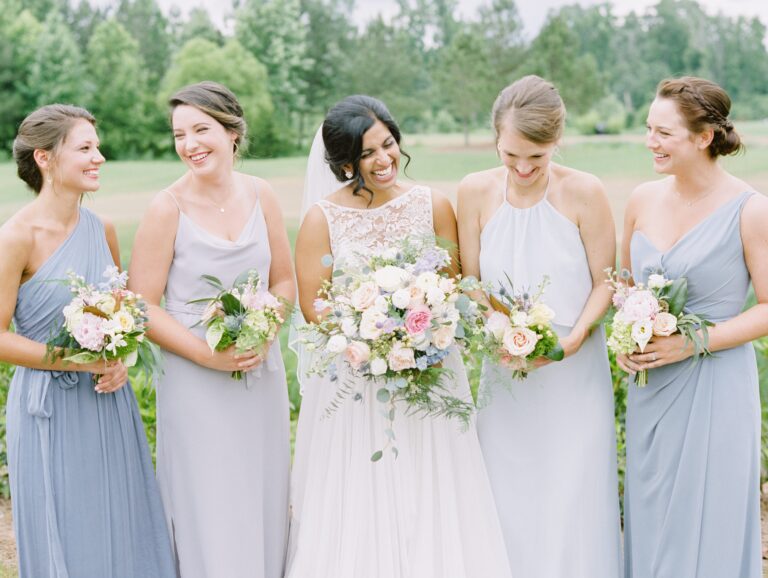 Bride and Bridesmaids Laugh Theia from Lana Addison Brideal and Amsale Monique Lhuillier and Nouvelle from Bella Bridesmaids Raleigh mix and match gowns in soft blue Casey Rose Photo
