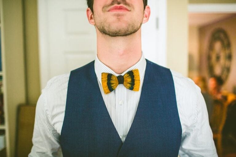 Groom Suit and Bow tie Ideas with yellow and black Feather bowtie for groom Carolyn Scott Photography