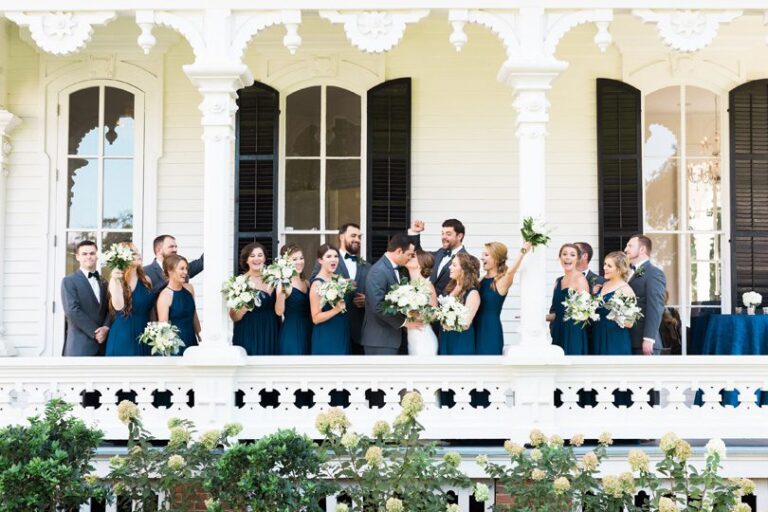 Bridal Party in navy and grey with white floral bouquets on porch at The Merrimon Wynne by Gather Together, Melissa Delorme