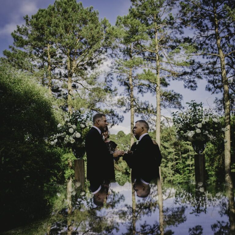 Grooms saying i do during their outdoor ceremony in NC at The Umstead by A Southern Soiree photographed by Adam Chapin Photography