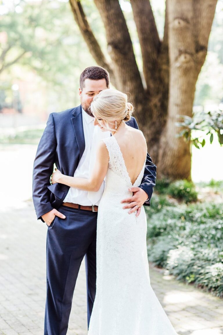 Wedding Photography of Bride and Groom embracing at MArket Hall Wedding in NC Annie Watts