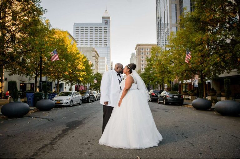 Bride and Groom kiss downtown raleigh at Raleigh Marriott City Center In His Image