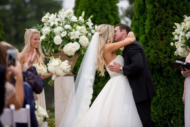 First Kiss between bride and groom at Outdoor wedding at Angus Barn in Raleigh, KMJ