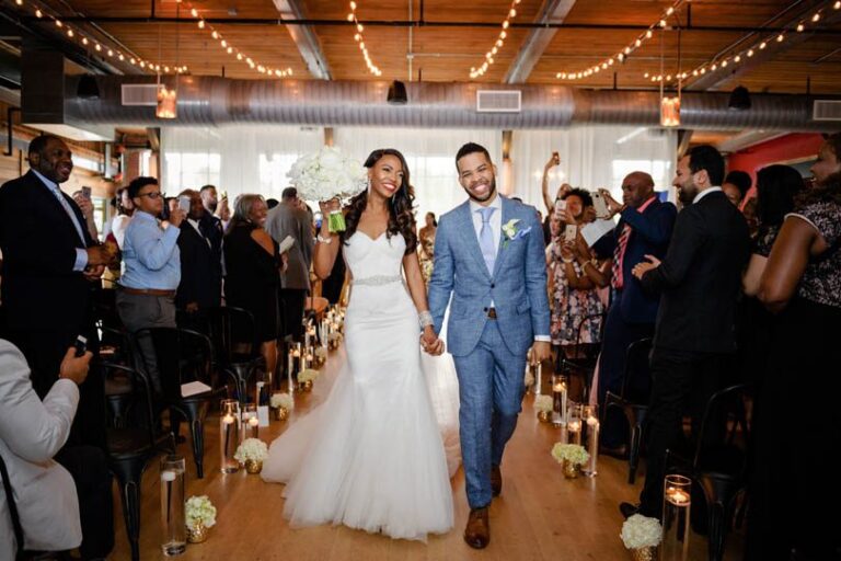 Bride and Groom walk down aisle after saying i do at Durham warehouse wedding venue, The Rickhouse, In His Image