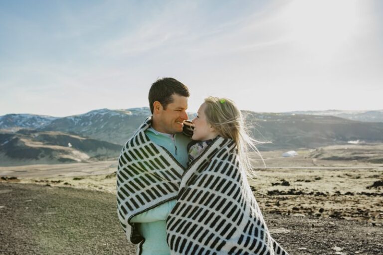 Couple Standing on cliff in iceland during honeymoon