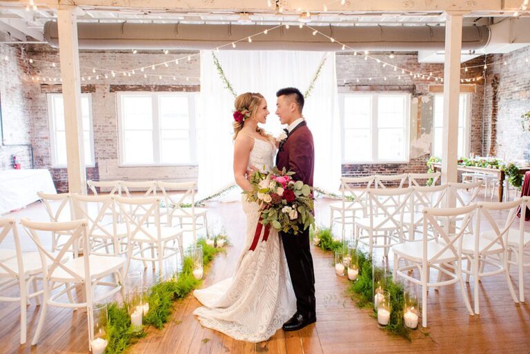 Bride and groom under chandelier at The Stockroom at 230, Mikkel Paige