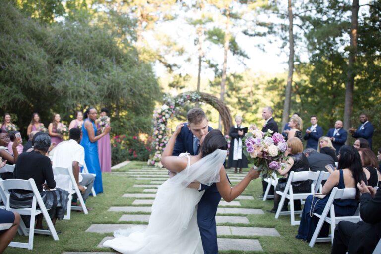 Bride and groom share a married kiss