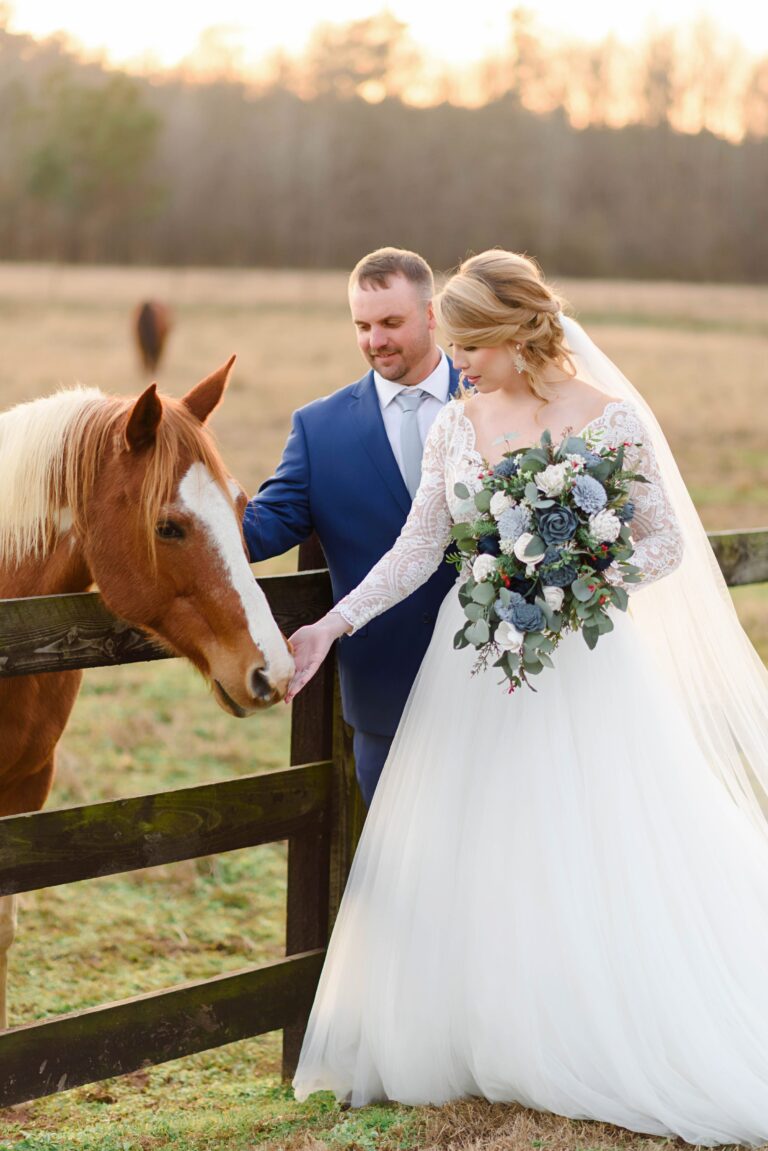 bride and groom pet a horse at Oakland Farm nc wedding venue