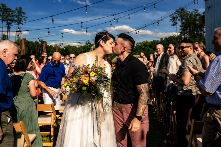 lgbtq wedding spouses kissing at ceremony