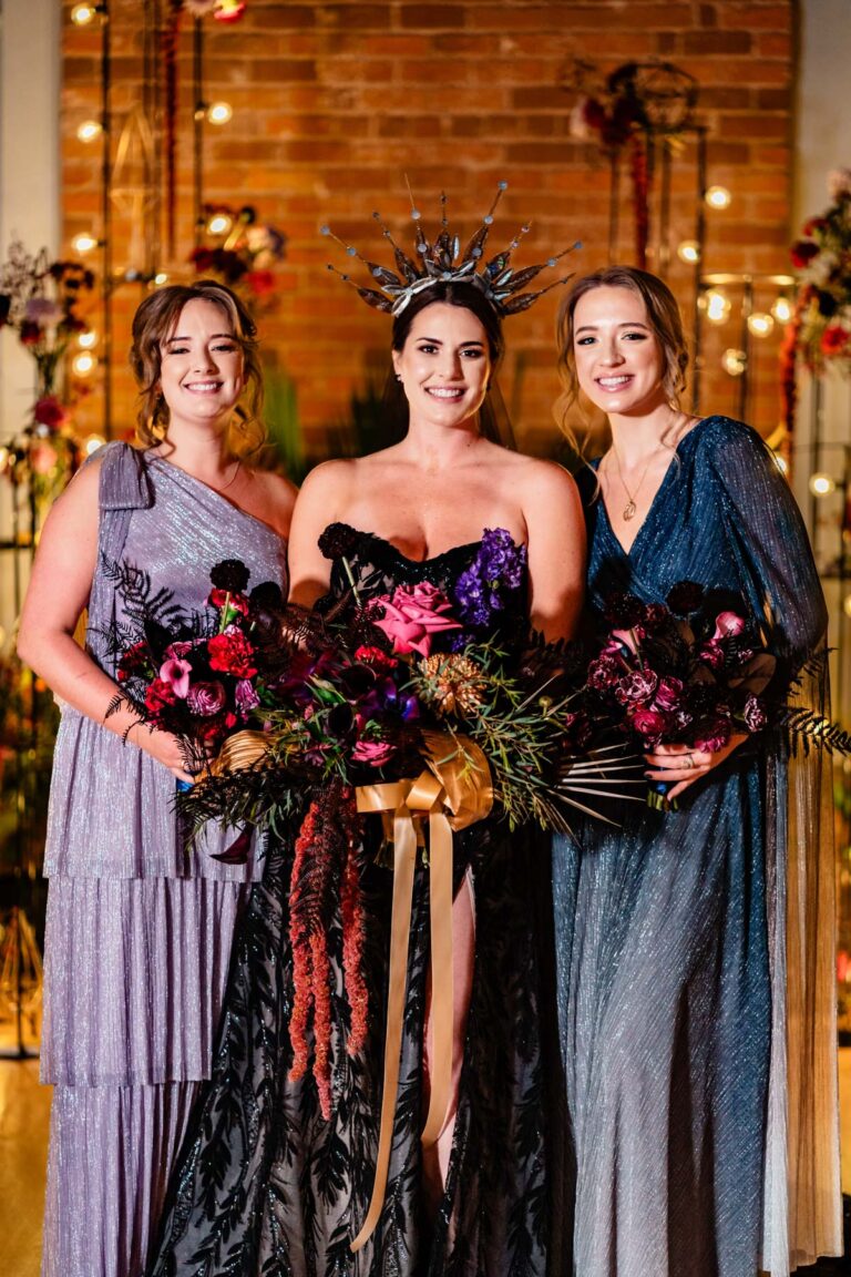 Black wedding dress – purple and blue bridesmaid dresses – red, purple and pink fantasy wedding florals